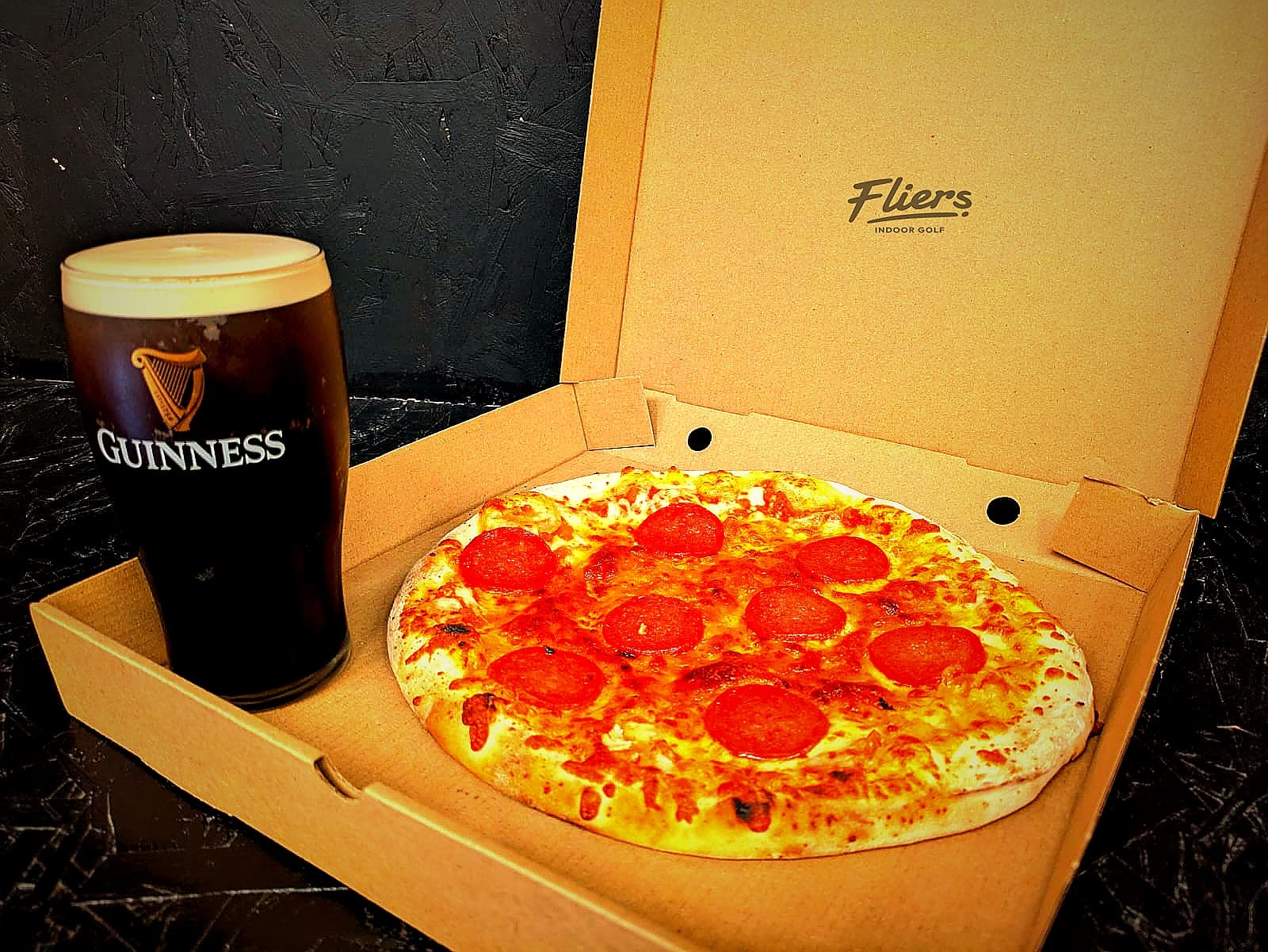Sourdough pizza and drinks at a Trackman bay at Fliers Indoor Golf, Liverpool